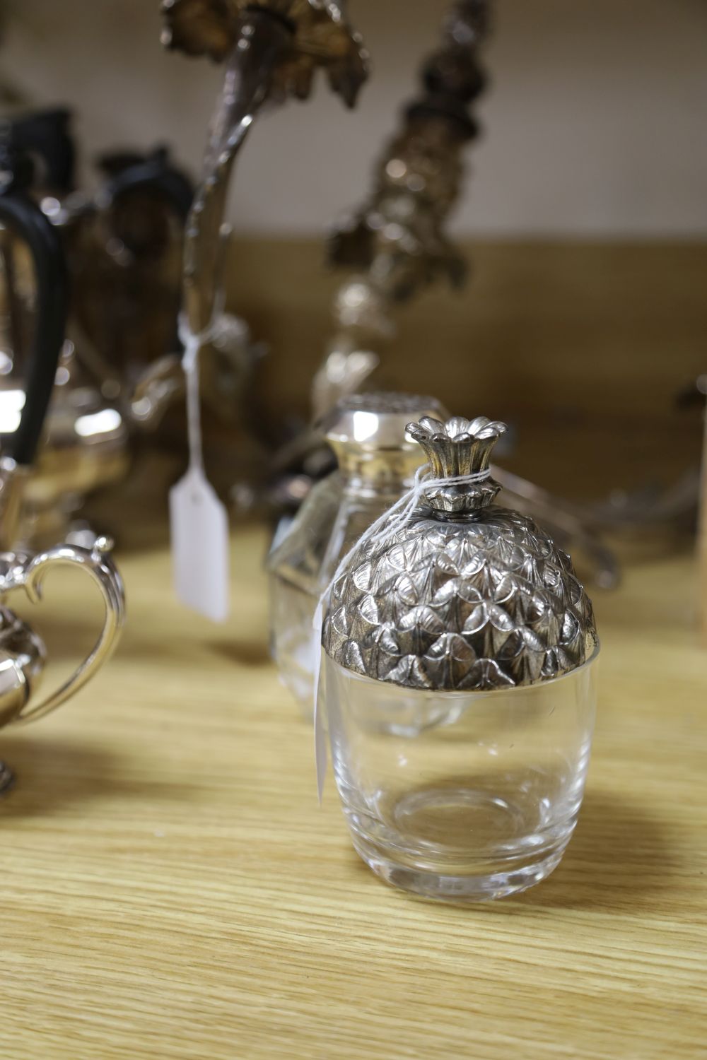 An ornate three-branch plated candelabrum with tulip sconces and sundry plated items,